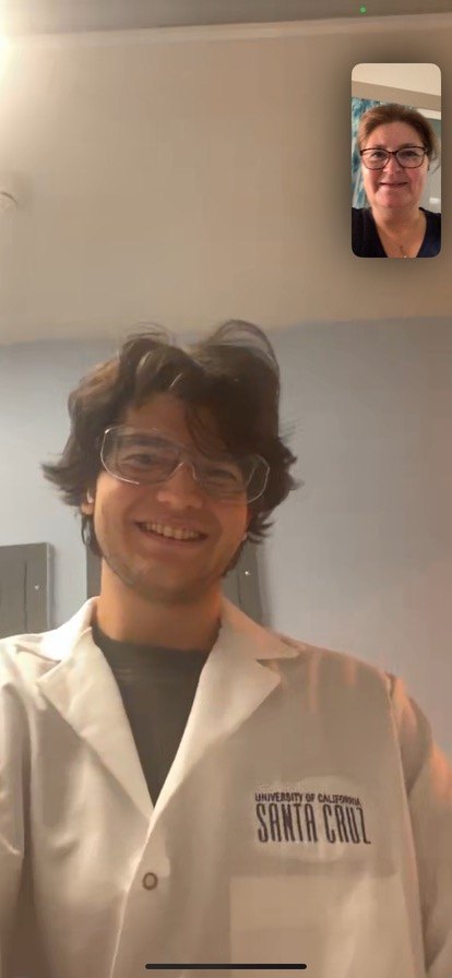 Emre smiling in a UC Santa Cruz lab coat